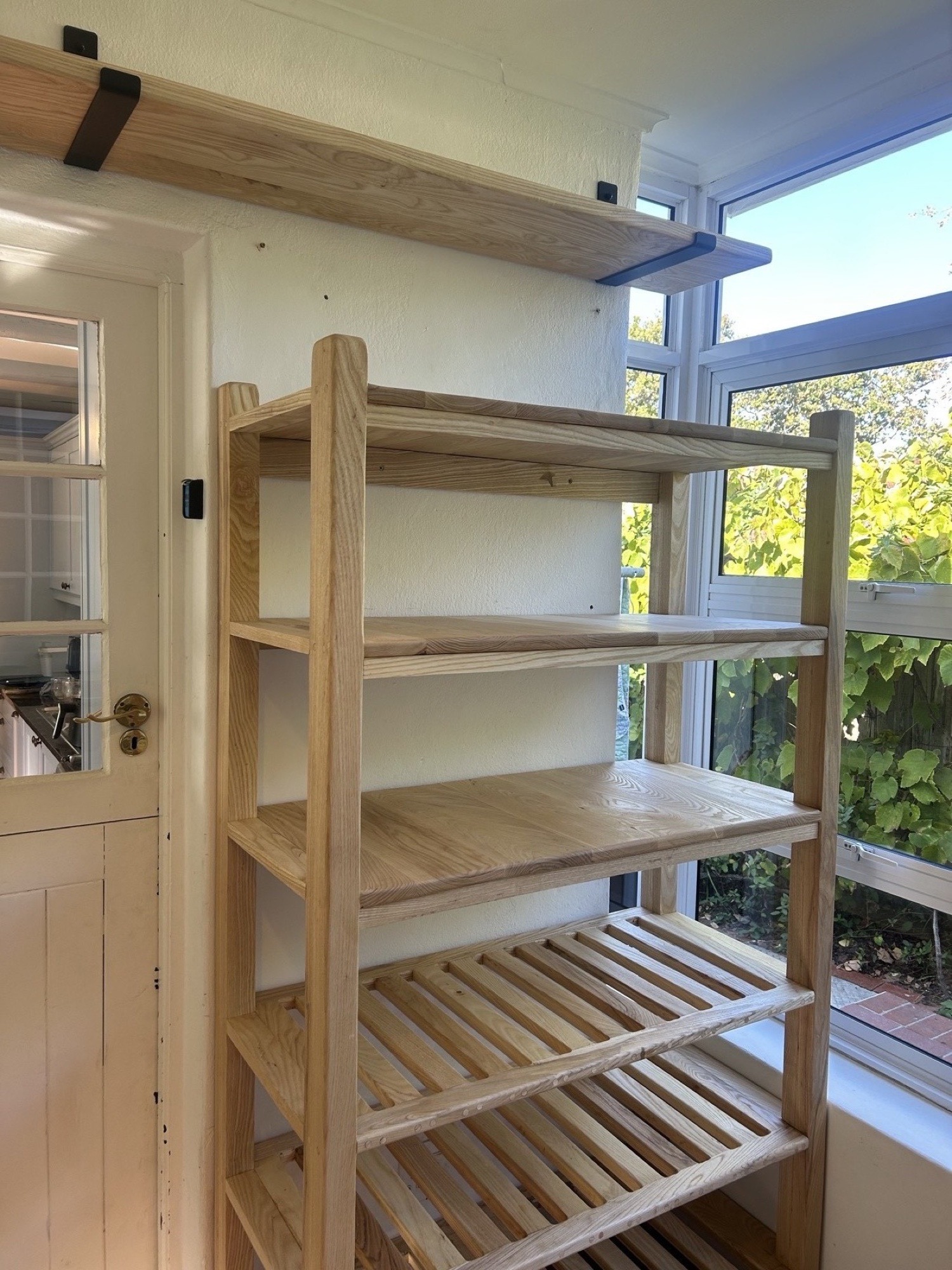 Free-standing oak shelving unit from the Amelie install, front view