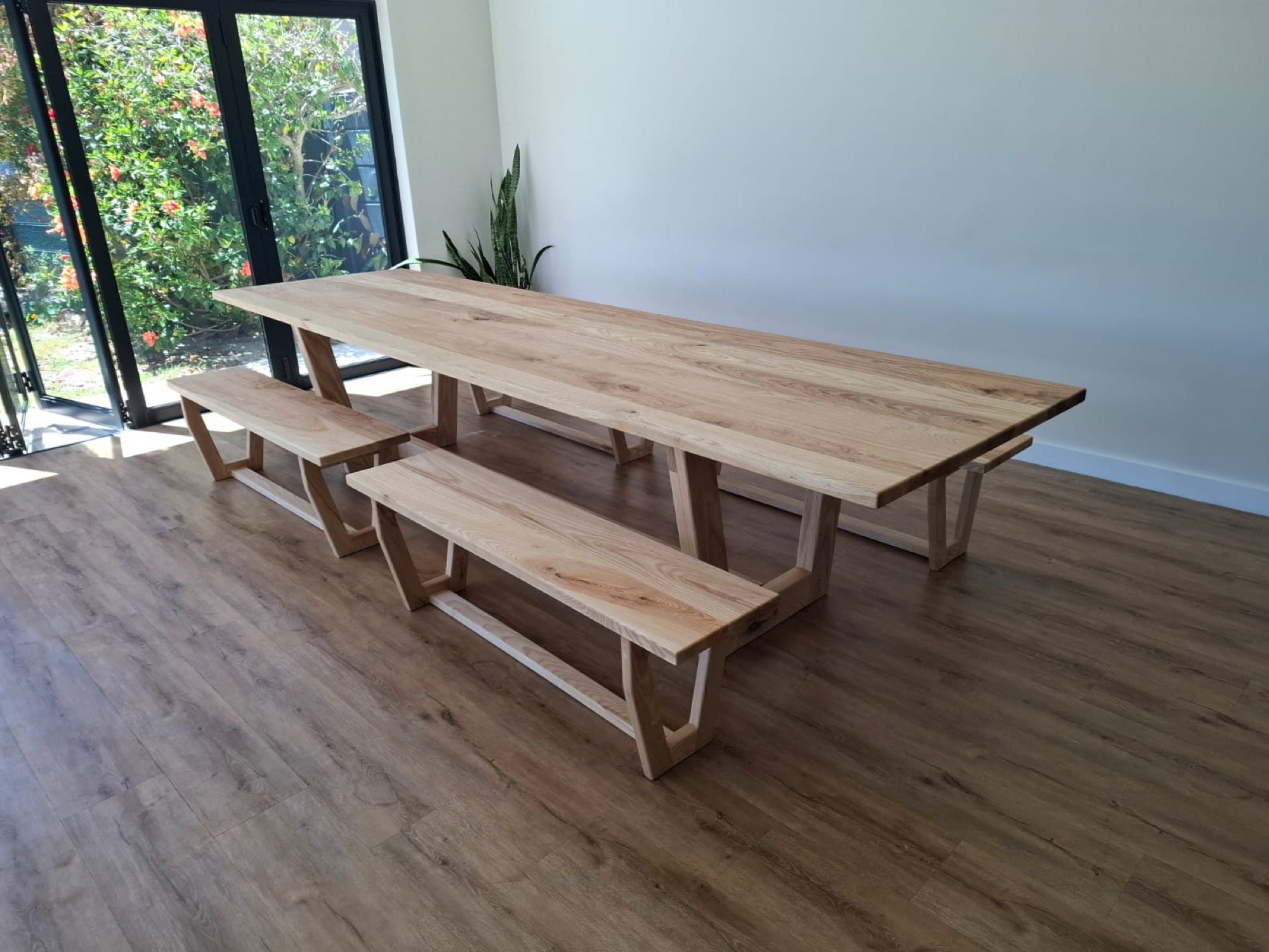 Long solid-timber dining table and benches